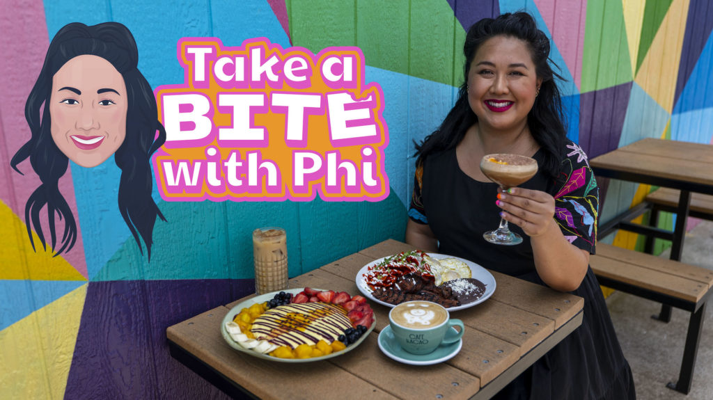 A photograph of Phi Nguyen outside the patio of Cafe Kacao with food dishes and the Take A Bite with Phi logo in the upper left corner.
