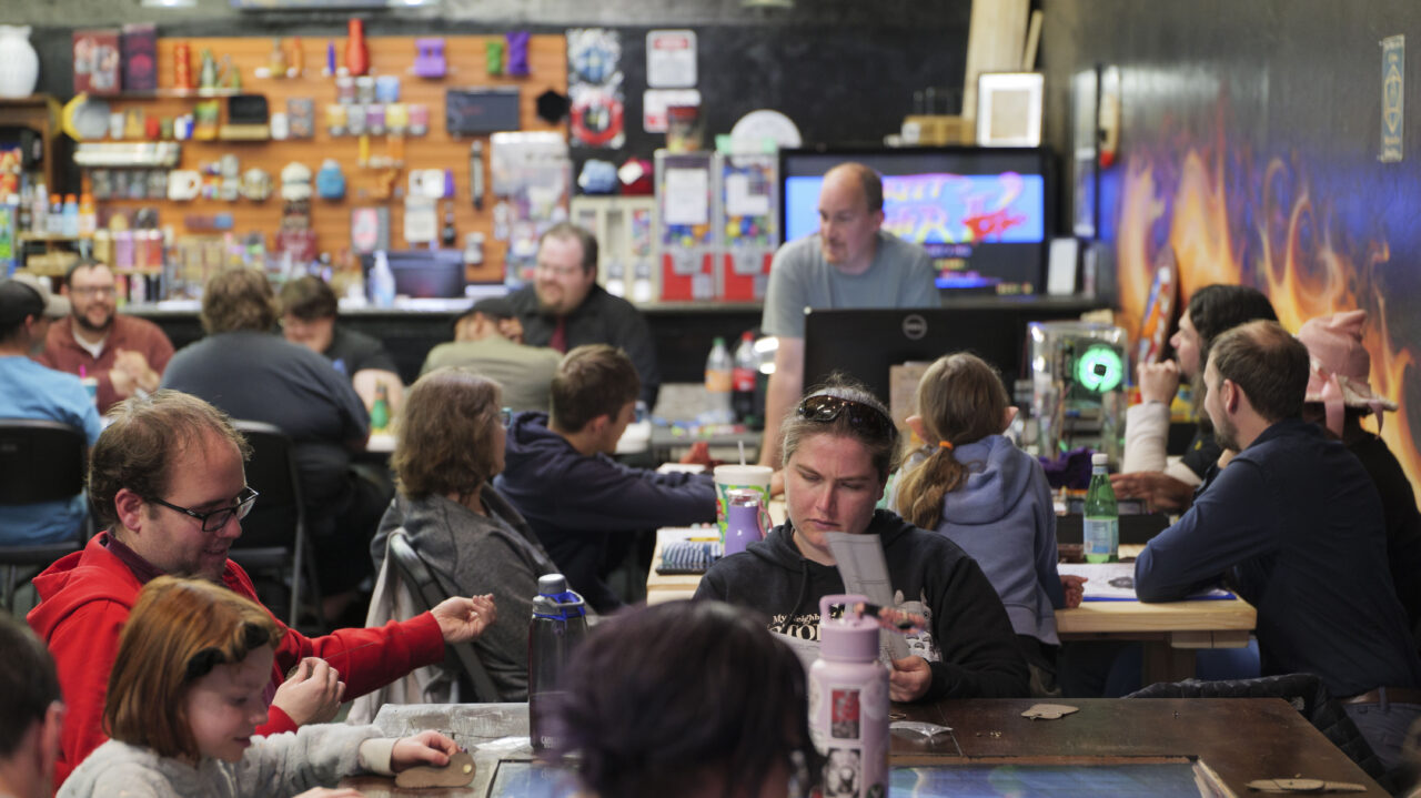 People gathered around for gaming night in a D&D lounge