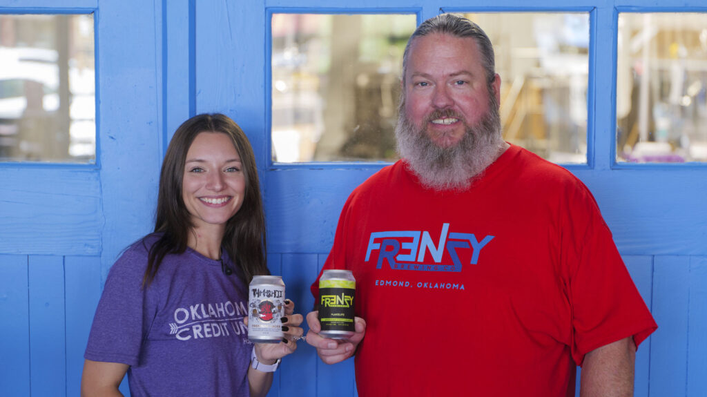 Photo of Phi holding up a can of beer with Matt Conner from Frenzy Brewing Company. 
