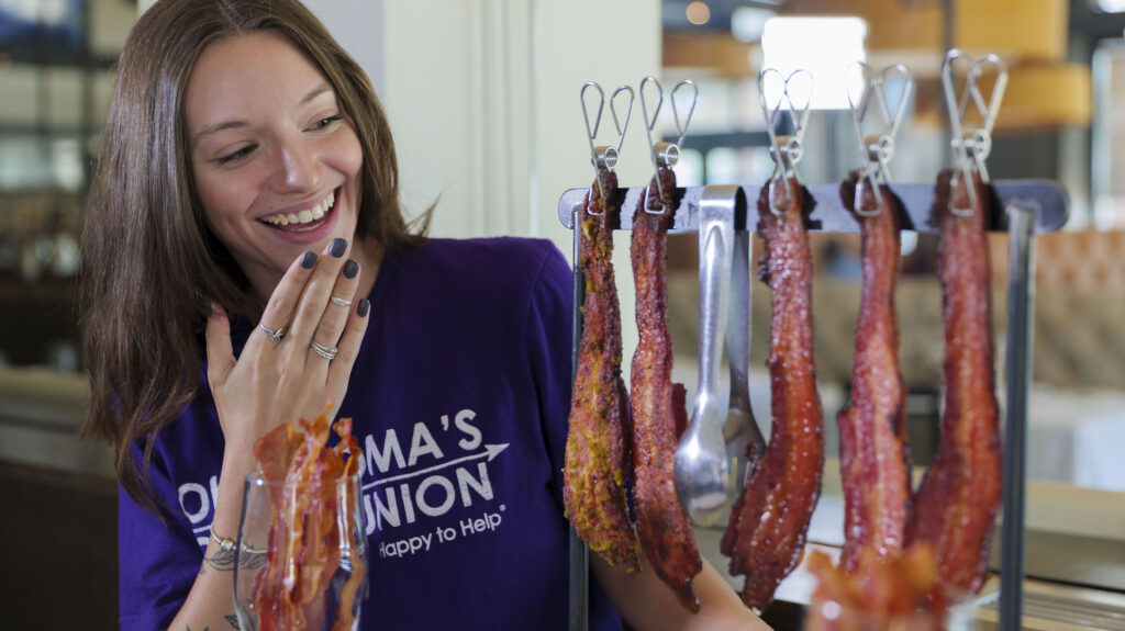 Photo of Bri looking at the Elevated Bacon from Broadway 10 Bar & Chophouse